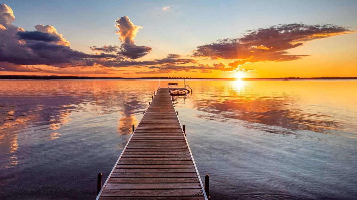 A serene view of a river landing at sunset, symbolizing a comfortable and well-planned retirement with Capitol Landing Wealth.