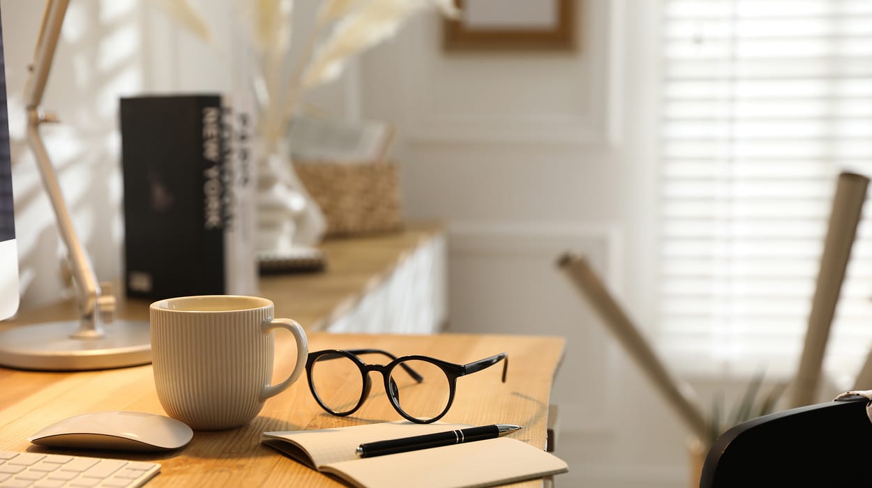 A pen and notebook on a sunlit desk, representing the meticulous retirement tax planning services at Capitol Landing Wealth.