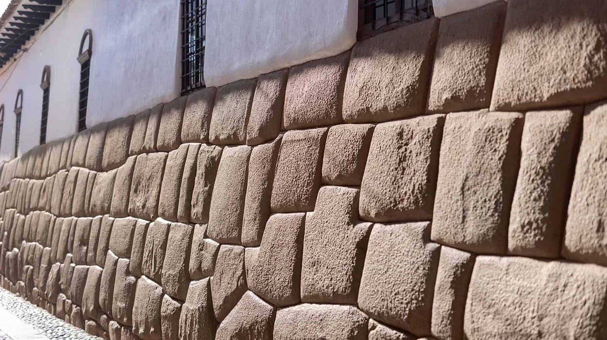 A close-up of an ancient, precision-cut Incan stone wall, symbolizing the strength and interlocking stability of a diversified retirement portfolio.