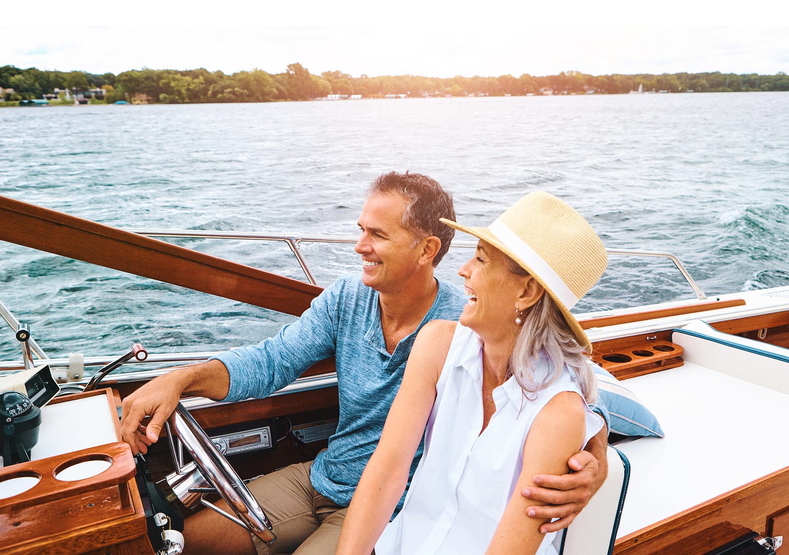 A retired couple on a boat on the James River, representing wealth preservation and distribution strategies by Capitol Landing Wealth, a fee only financial advisor in Williamsburg VA.