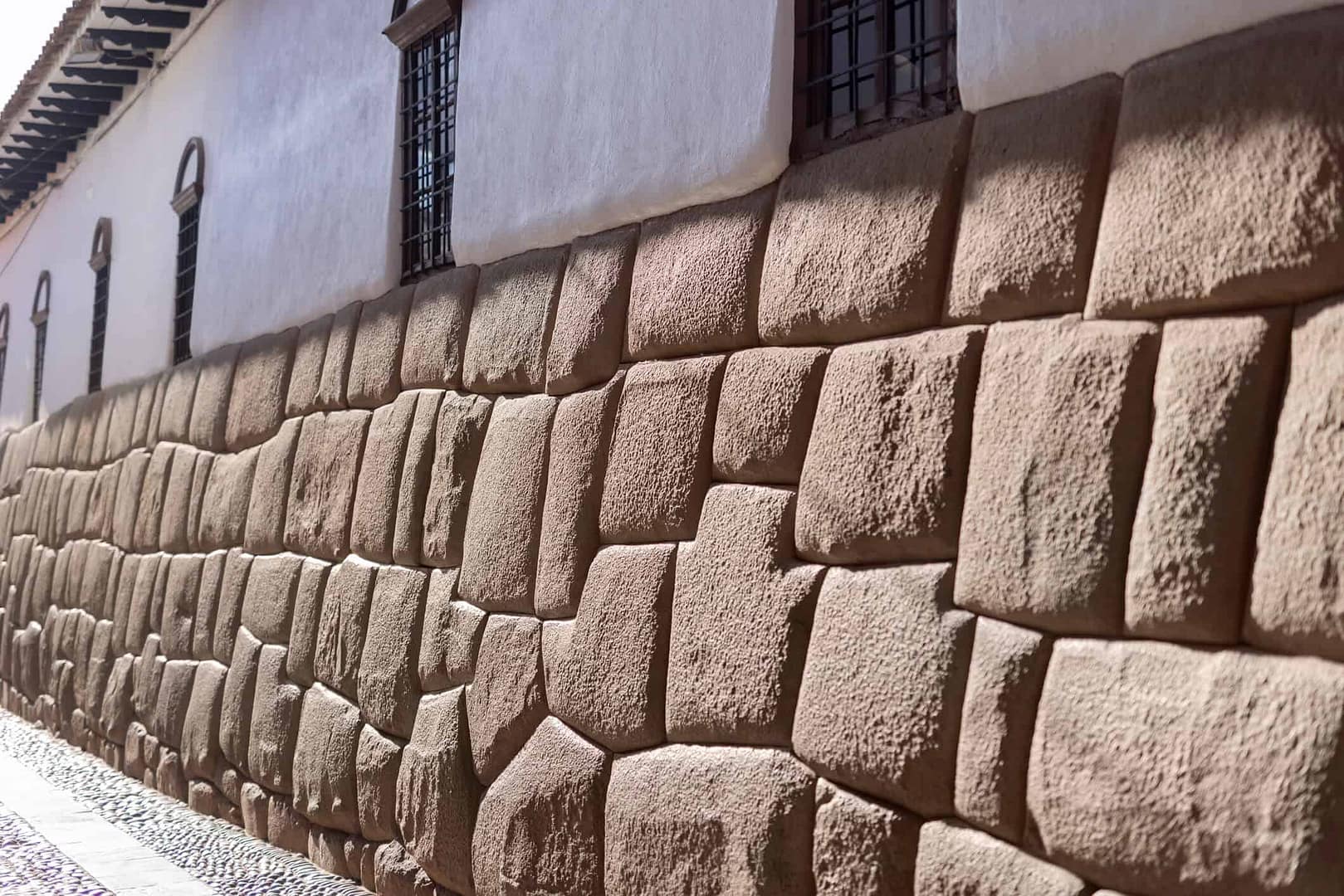 A close-up of an ancient, precision-cut Incan stone wall, symbolizing the strength and interlocking stability of a diversified retirement portfolio.