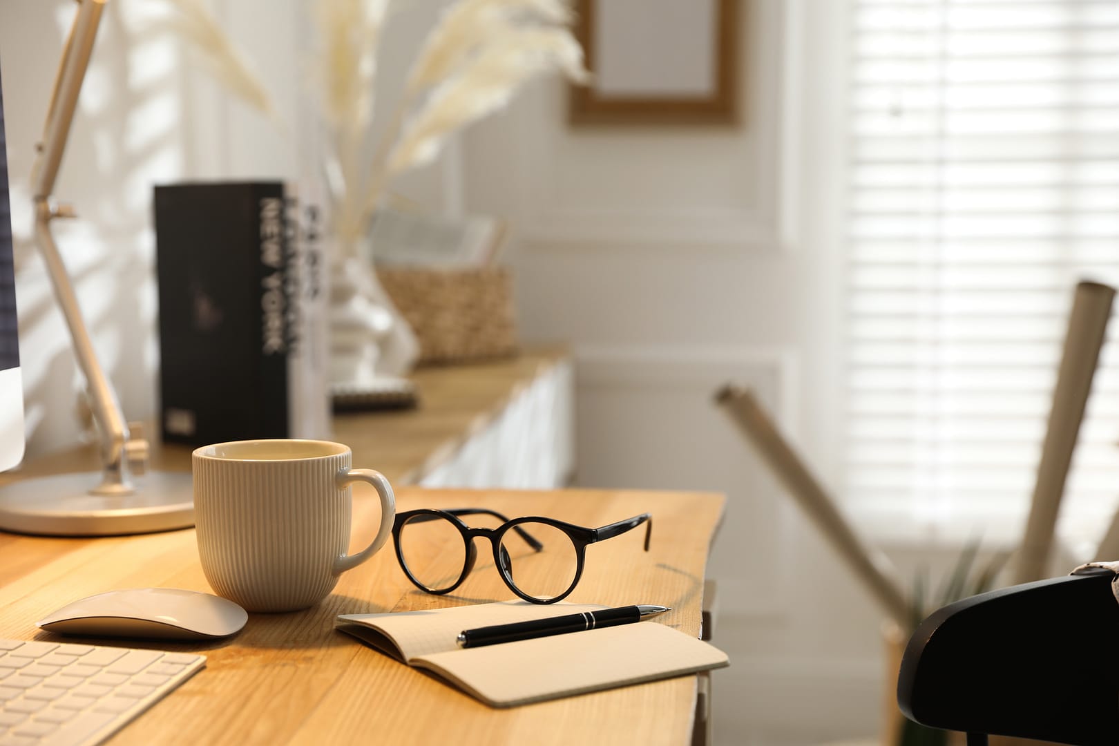 A pen and notebook on a sunlit desk, representing the meticulous retirement tax planning services at Capitol Landing Wealth.